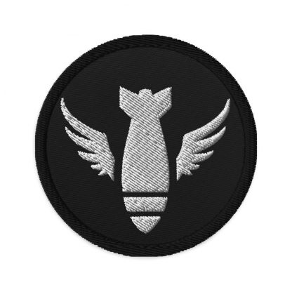 Black embroidered patch with white logo of winged bomb falling