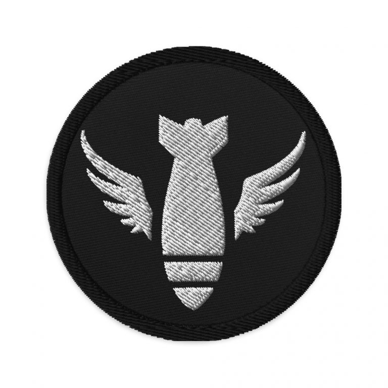 Image of a Black embroidered patch with white logo of winged bomb falling