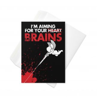 5 inch by 7 inch greetings card with a cherub firing a rifle with text saying "I'm aiming for your brains" on a black background